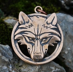 Wolf's head in a ring, bronze pendant
