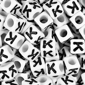 White plastic bead 7 mm with letter K