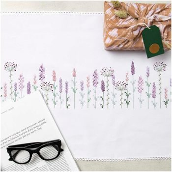 Kit for embroidering a table-cloth with a floral design