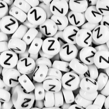 White plastic bead 7x4 mm with letter Z