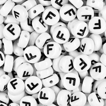 White plastic bead 7x4 mm with letter F