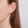 Boucles d'oreilles créoles en or rose avec un diamant