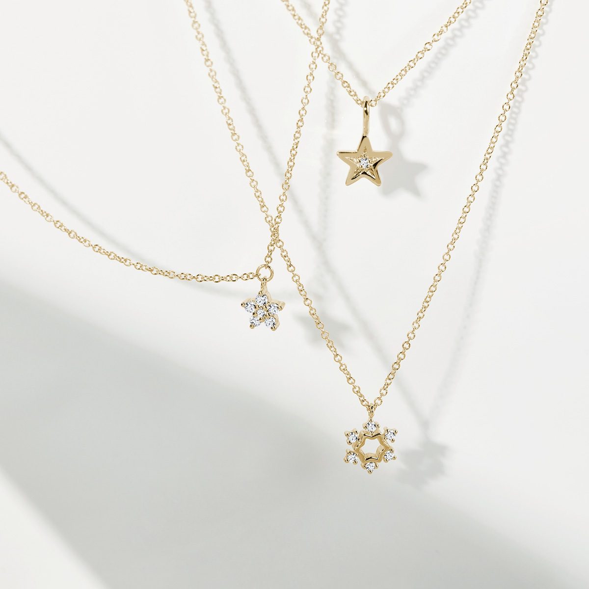 Gold necklaces with playful pendants - KLENOTA