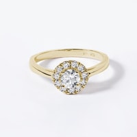 Diamond halo engagement ring in yellow gold