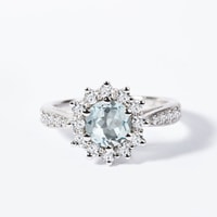 Halo engagement ring with an aquamarine and diamonds in white gold