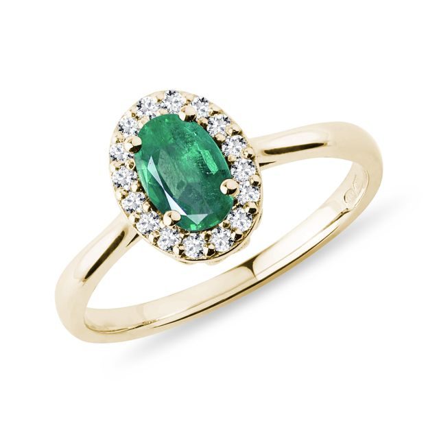Emerald and diamond halo ring in yellow gold