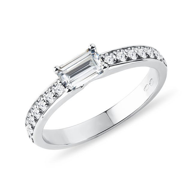 Emerald cut moissanite and diamond ring in white gold
