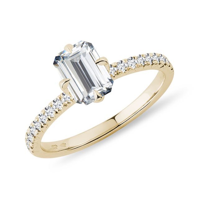 Modern emerald cut diamond engagement ring in yellow gold