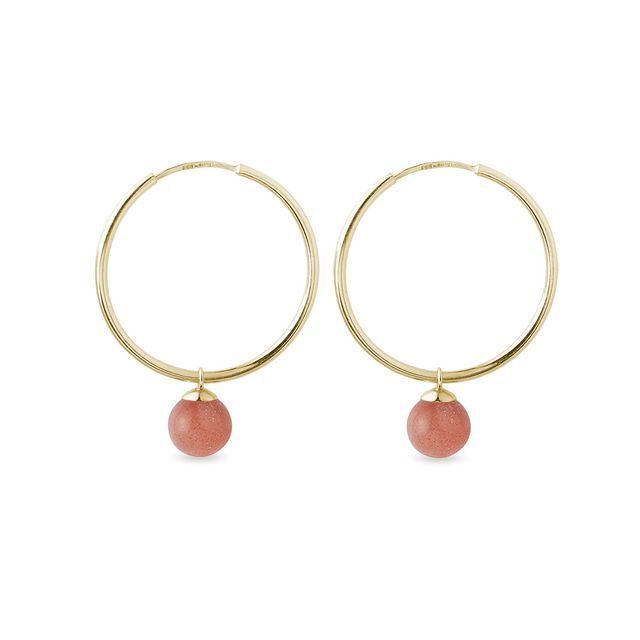 Gold hoop earrings with round sunstone pendants