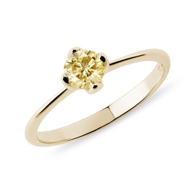 A gold ring with yellow diamond