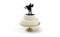 Silhouette of newlyweds in arms - wedding cake figures