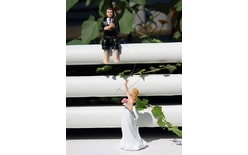 Groom with rod catches the bride 50% action - wedding cake figurines