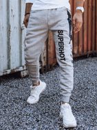 Zaujímavé pánske tepláky s nápisom v sivej farbe