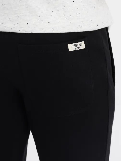 Zaujímavé čierne tepláky V5 PABS-0206