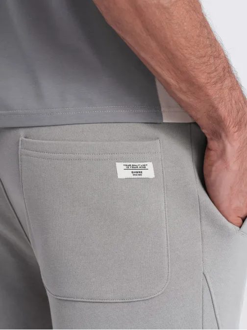 Šedé tepláky s trendy prešívaním V8 PABS-0173