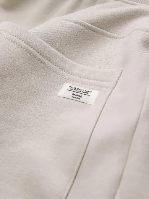 Béžové tepláky s trendy prešívaním V1 PABS-0173
