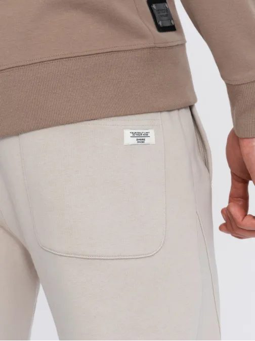 Béžové tepláky s trendy prešívaním V1 PABS-0173