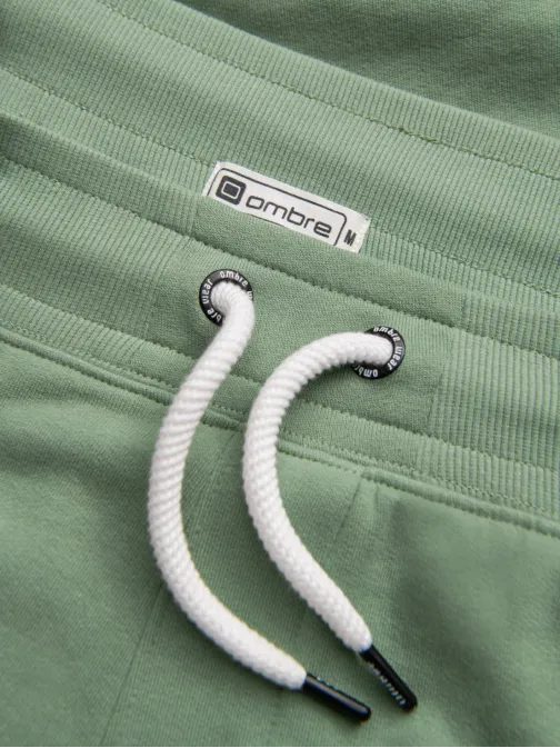 Zelené tepláky s trendy prešívaním V3 PABS-0173