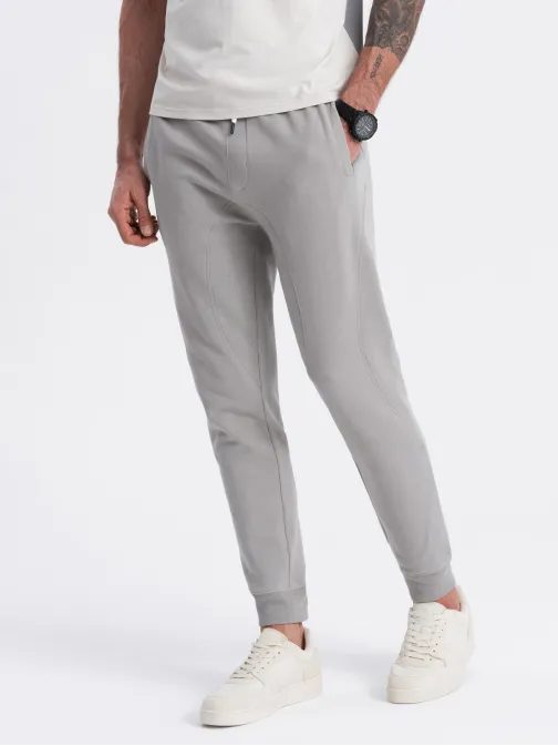 Šedé tepláky s trendy prešívaním V8 PABS-0173