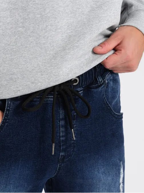 Divatos sötétkék farmer jogger nadrág dekoratív kopásokkal V1 PADJ-0153