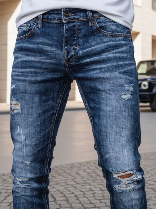 Atraktivne modre kavbojke z luknjami