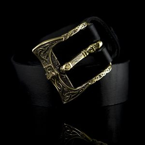 Brass belt buckle with a Viking axe design