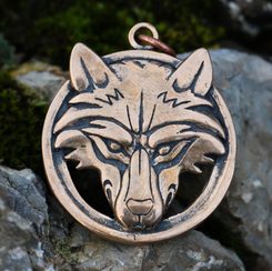 Wolf's head in a ring, bronze pendant