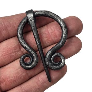 Forged cloak brooch