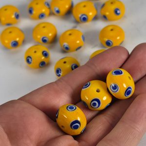 Celtic glass bead with eyes, yellow
