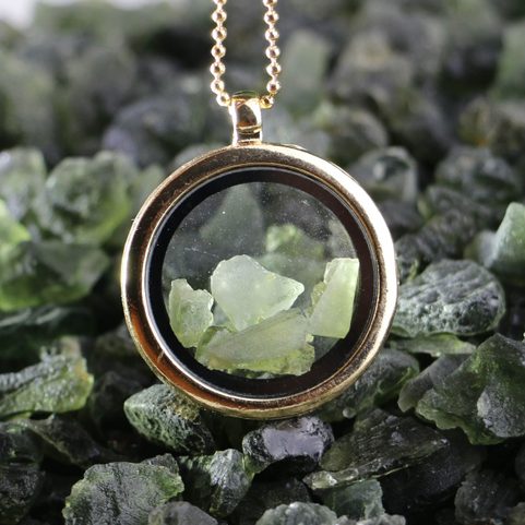MOLDAVITE STEEL FLOATING LOCKET, GOLD COL.