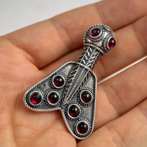 MEROVINGIAN SILVER AND GARNET CICADA BROOCH, 5TH CENTURY