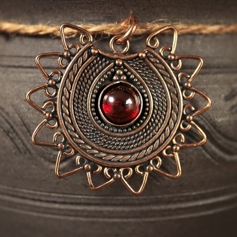 LADA, DARK AGE JEWEL, THE 9TH CENTURY, BRONZE AND GEMSTONE