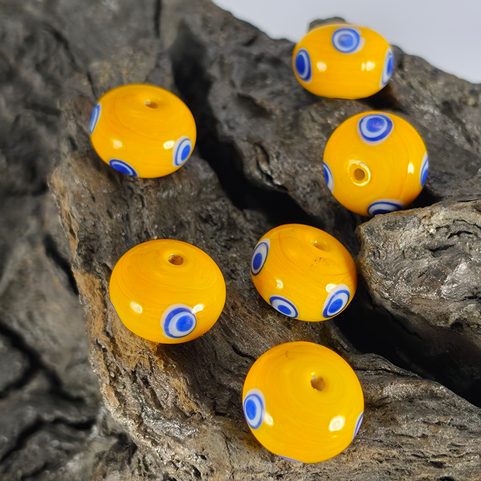 CELTIC GLASS BEAD WITH EYES, YELLOW