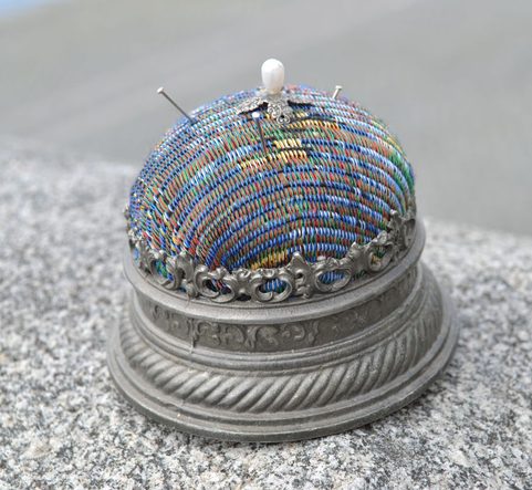 LARGE HISTORICAL PINCUSHION, TIN