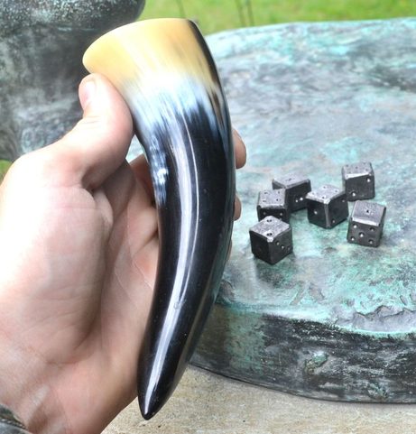 SIX FORGED DICE AND A HORN CUP