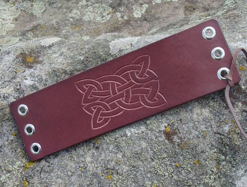 CLOCH, LACED LEATHER CUFF, HAND CARVED