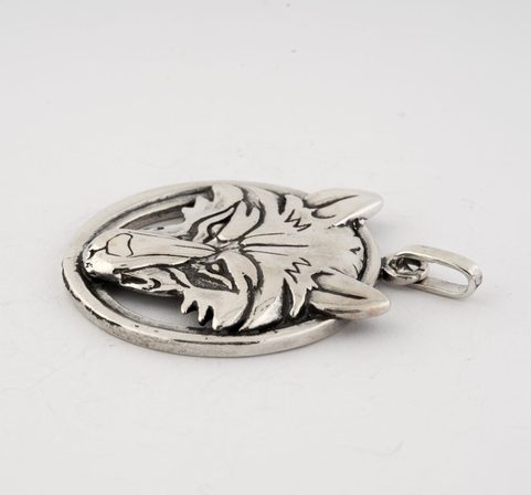 WOLF'S HEAD IN A RING, STERLING SILVER PENDANT