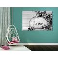 CANVAS PRINT WITH THE INSCRIPTION "LOVE" ON A STONE IN BLACK AND WHITE - BLACK AND WHITE PICTURES - PICTURES