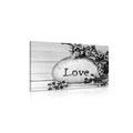 CANVAS PRINT WITH THE INSCRIPTION "LOVE" ON A STONE IN BLACK AND WHITE - BLACK AND WHITE PICTURES - PICTURES