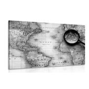 Canvas print black and white world map with a magnifying glass