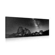 Picture starry sky over rocks in black & white