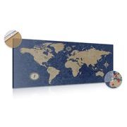 Picture on cork world map with compass in retro style on blue background