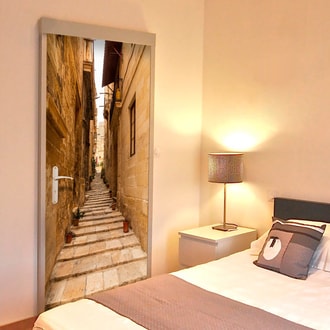 Photo wallpaper on the door with a narrow alley motif