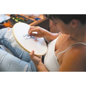 Kit for embroidering a table-cloth with a coffee design