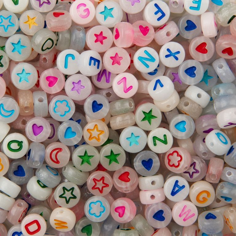 A set of colored plastic beads 7 x 4 mm with letters and symbols that glow in the dark