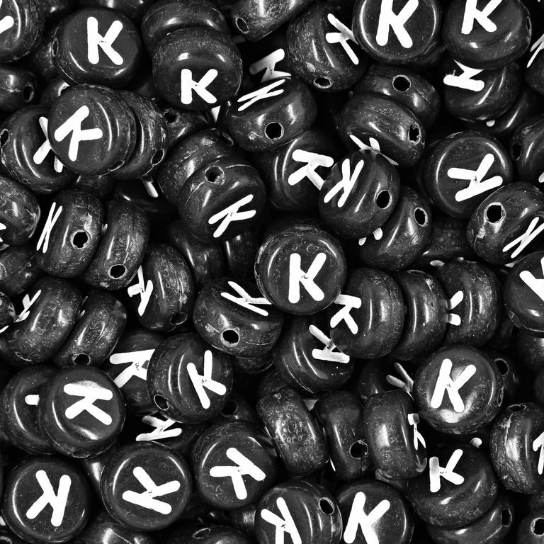 Black plastic bead 7x4 mm with letter K