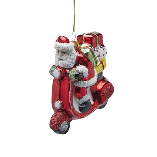 Vianočná sklenená ozdoba Santa s darčekmi na skútri, 10x10x6 cm