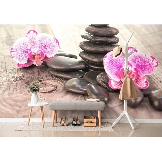 Tapéta orchidea és Zen kövek egy fából készült háttéren