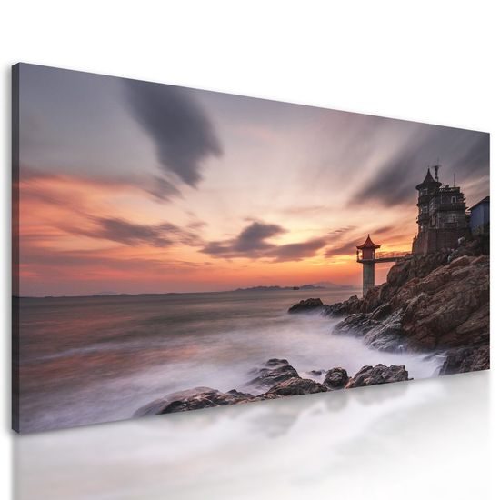 Kép világítótorony mögé lemenő nap