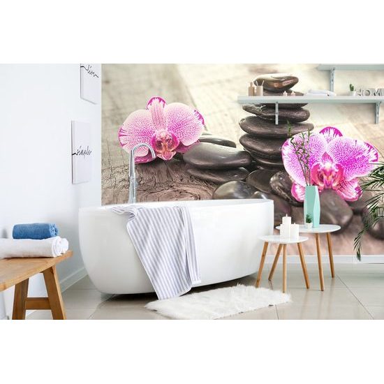Tapéta orchidea és Zen kövek egy fából készült háttéren
